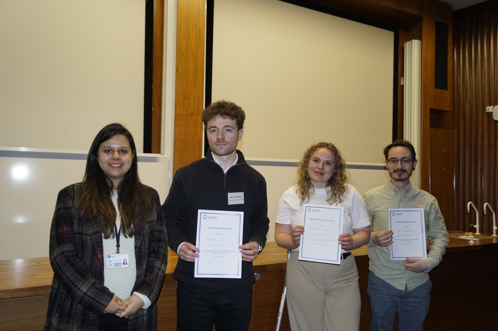 Thomas Ball, Charlotte McIvor and Denis Hartmann receive their poster prizes